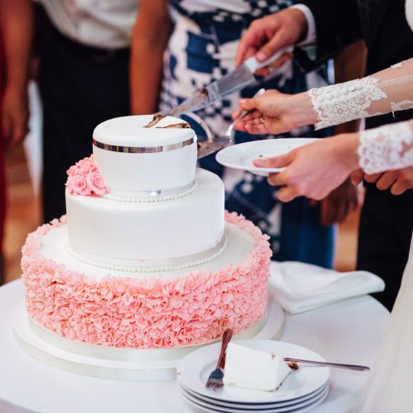 newlyweds-happily-cut-and-taste-the-wedding-cake.jpg